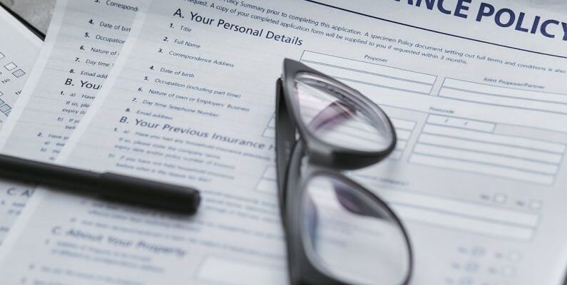 Insurance Policies - Black Framed Eyeglasses on White Paper